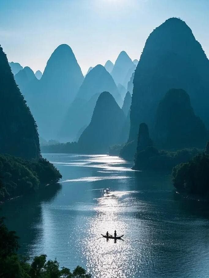 Li River cruise — karst peaks from emerald waters