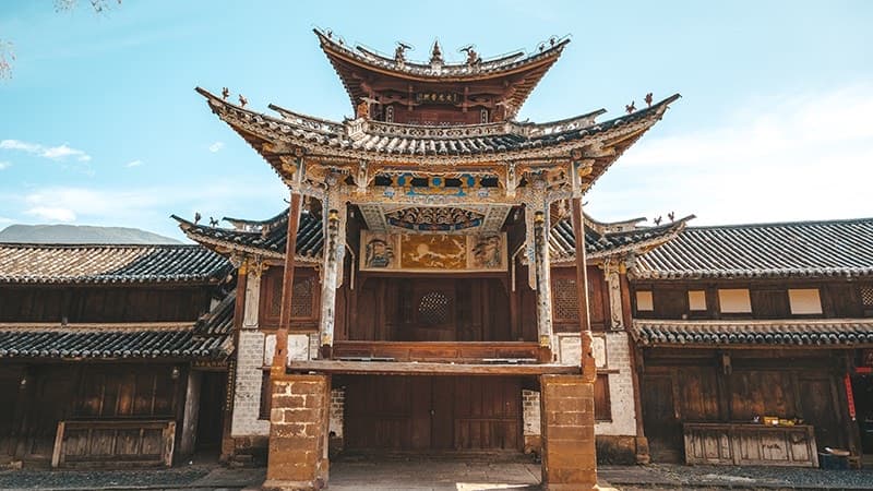 Shaxi Ancient Town — 600-year-old cobblestone market square at golden hour